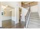 Foyer with staircase and an open view to the dining room with wainscoting at 171 Osier Dr, Mcdonough, GA 30252