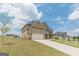 Attractive two-story house with brick and siding, a two-car garage, and a long driveway on a sunny day at 171 Osier Dr, Mcdonough, GA 30252