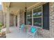 Inviting front porch with chairs, decorative pillows, and a hanging light fixture at 171 Osier Dr, Mcdonough, GA 30252