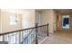 Hallway view with wrought iron staircase and an elegant chandelier at 171 Osier Dr, Mcdonough, GA 30252