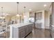 The kitchen island has granite countertops, gray cabinets, and pendant lights at 171 Osier Dr, Mcdonough, GA 30252