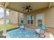 Cozy covered patio with cushioned chairs and blue rug, offering a comfortable outdoor living space at 171 Osier Dr, Mcdonough, GA 30252