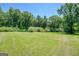 Large grassy backyard with lush green trees and a serene setting at 70 Country Meadows Ln, Covington, GA 30014