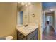 Bathroom features a modern sink vanity with a neutral countertop and stylish fixtures at 70 Country Meadows Ln, Covington, GA 30014