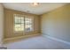 Bright bedroom with a large window, plush carpeting, and neutral paint at 70 Country Meadows Ln, Covington, GA 30014
