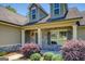Close up of the front of a single-Gathering home showcasing the stone accents and manicured bushes at 70 Country Meadows Ln, Covington, GA 30014