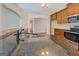 Granite countertops, stainless steel appliances and wood cabinetry in an open concept kitchen at 70 Country Meadows Ln, Covington, GA 30014