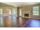Open living area featuring hardwood floors, fireplace, and large windows that fill the room with natural light at 70 Country Meadows Ln, Covington, GA 30014