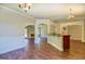 Open living space features hardwood floors, modern archways and pillars, a fireplace, and a kitchen island at 70 Country Meadows Ln, Covington, GA 30014