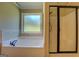 Bathroom features a soaking tub, a walk-in shower with a glass door, and neutral paint at 70 Country Meadows Ln, Covington, GA 30014