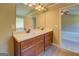 Bathroom features a double vanity, a large mirror, a ceiling fan, and neutral paint at 70 Country Meadows Ln, Covington, GA 30014