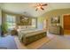 Spacious bedroom boasts a tray ceiling, soft carpet, a ceiling fan, and neutral paint at 70 Country Meadows Ln, Covington, GA 30014