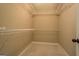 Walk-in closet boasts neutral paint, metal racks, and soft carpet at 70 Country Meadows Ln, Covington, GA 30014