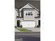 Two-story townhome featuring a two-car garage and neutral siding at 2306 Santa Fe St # 9, Morrow, GA 30260