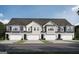 Charming townhomes featuring unique architectural details and two-car garages at 2306 Santa Fe St # 9, Morrow, GA 30260