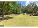 Large backyard with storage shed, mature trees and wood privacy fence at 75 Mcintosh Estates Ct, Sharpsburg, GA 30277