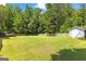 Large, level backyard with wooden fence, storage shed, and deck, perfect for outdoor activities at 75 Mcintosh Estates Ct, Sharpsburg, GA 30277