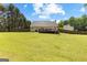 View of the backyard showcasing the wooden fence, large trees and deck at 75 Mcintosh Estates Ct, Sharpsburg, GA 30277