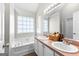 Primary bathroom with double sinks, a soaking tub, and a large window at 75 Mcintosh Estates Ct, Sharpsburg, GA 30277