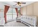 Charming Bedroom with natural light, a cozy chair, and a crib at 75 Mcintosh Estates Ct, Sharpsburg, GA 30277