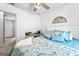 The main bedroom features a ceiling fan and a large window with curtains at 75 Mcintosh Estates Ct, Sharpsburg, GA 30277