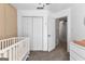 Bright Bedroom with a white crib, closet, and view to a hallway and dresser at 75 Mcintosh Estates Ct, Sharpsburg, GA 30277