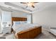 Primary bedroom with wooden bed frame, ceiling fan, and grey walls at 75 Mcintosh Estates Ct, Sharpsburg, GA 30277