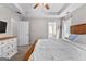 Primary bedroom with a wooden bed frame, tray ceiling, and view of ensuite bath at 75 Mcintosh Estates Ct, Sharpsburg, GA 30277