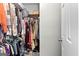 Walk-in closet filled with clothing and storage items at 75 Mcintosh Estates Ct, Sharpsburg, GA 30277