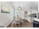 Bright dining area features a modern chandelier, wood floors, and a table set for four in a well-lit space at 75 Mcintosh Estates Ct, Sharpsburg, GA 30277