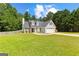 Charming house exterior highlighting its well-kept lawn, gray siding, and a two-car garage at 75 Mcintosh Estates Ct, Sharpsburg, GA 30277
