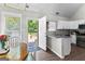 Bright eat-in kitchen featuring granite counters, white cabinets, stainless appliances and door to back deck at 75 Mcintosh Estates Ct, Sharpsburg, GA 30277