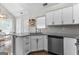 Bright kitchen boasts stainless steel appliances, granite countertops, and white cabinets at 75 Mcintosh Estates Ct, Sharpsburg, GA 30277