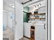 Contemporary laundry room with open shelves and modern washer and dryer at 75 Mcintosh Estates Ct, Sharpsburg, GA 30277