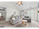 The living room offers a large gray sectional sofa and a ceiling fan in a well-lit space at 75 Mcintosh Estates Ct, Sharpsburg, GA 30277