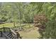 An expansive backyard with mature trees and landscaping, offering a private outdoor retreat at 1000 Pleasance Grv, Peachtree City, GA 30269
