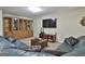 Basement entertainment area features large sectional sofa, tv, and a decorative bookcase at 1000 Pleasance Grv, Peachtree City, GA 30269