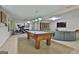 Finished basement featuring a pool table, media area with a sectional, and exercise equipment at 1000 Pleasance Grv, Peachtree City, GA 30269