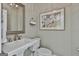 Half bathroom with decorative mirror, towel rack, framed art, and toilet at 1000 Pleasance Grv, Peachtree City, GA 30269