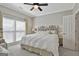 Comfortable bedroom featuring a decorative headboard, ceiling fan, and light neutral paint at 1000 Pleasance Grv, Peachtree City, GA 30269