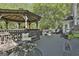 Large deck area with gazebo, comfortable seating, and a peaceful backyard setting at 1000 Pleasance Grv, Peachtree City, GA 30269
