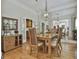 Elegant dining room featuring a wooden table, stylish chairs, and decorative mirror at 1000 Pleasance Grv, Peachtree City, GA 30269