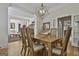 Open-concept dining room with modern light fixture and light-filled ambiance at 1000 Pleasance Grv, Peachtree City, GA 30269