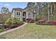Beautiful home boasting manicured lawn, mature trees and colorful azaleas at 1000 Pleasance Grv, Peachtree City, GA 30269