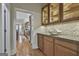 Hallway view featuring wood floors and built-in cabinets with display lighting and countertops at 1000 Pleasance Grv, Peachtree City, GA 30269