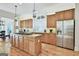 Spacious kitchen with island, stainless steel refrigerator, and ample cabinet space at 1000 Pleasance Grv, Peachtree City, GA 30269