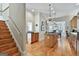 Elegant kitchen with island, staircase, and hardwood floors at 1000 Pleasance Grv, Peachtree City, GA 30269