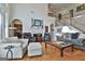 Bright, open living room with hardwood floors, fireplace, and staircase at 1000 Pleasance Grv, Peachtree City, GA 30269