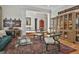 A cozy living room featuring detailed oriental rug, glass coffee table, and elegant display cases at 1000 Pleasance Grv, Peachtree City, GA 30269