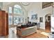 Bright, light-filled living room with large windows, a fireplace, and comfortable seating at 1000 Pleasance Grv, Peachtree City, GA 30269